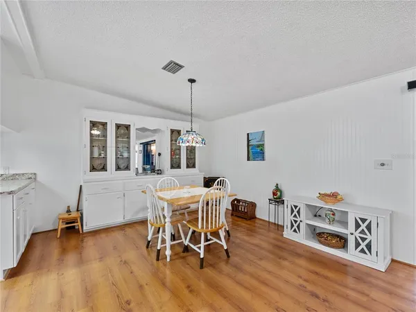 a dining room with furniture and wooden floor