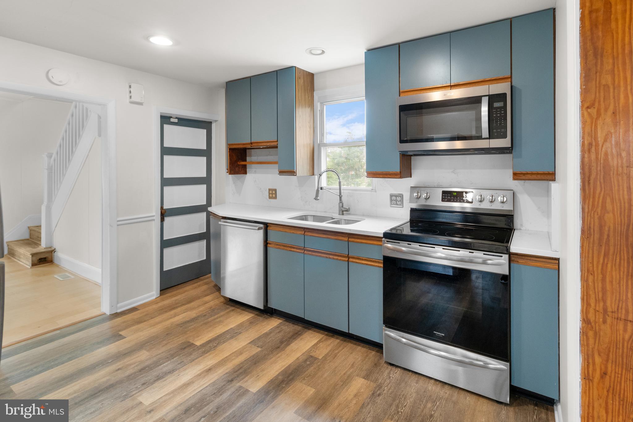 1504 Taylor Avenue, Unit A Parkville, MD 21234 - Photo 13 of 27 a kitchen with stainless steel appliances a stove a sink and a microwave