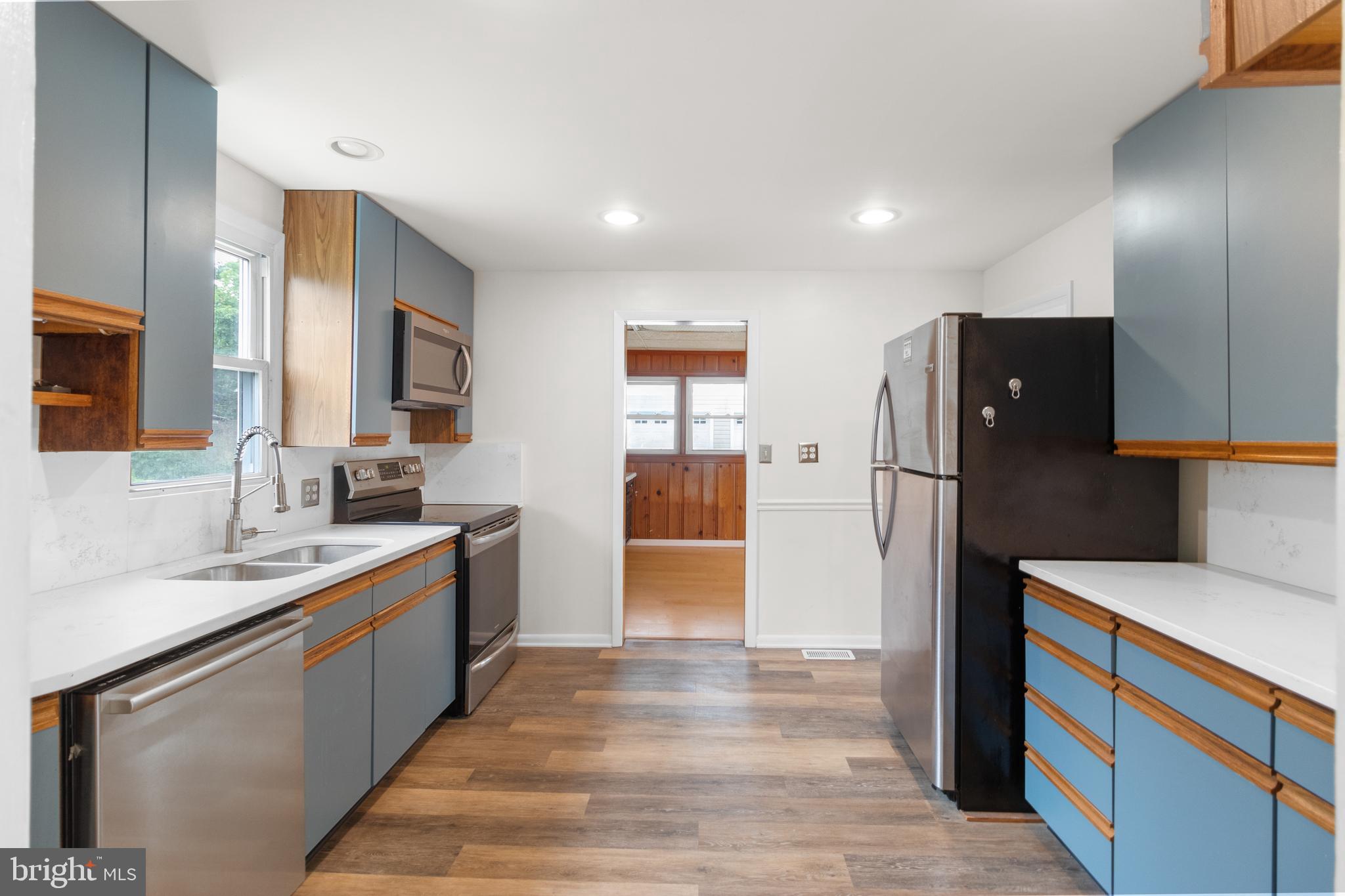 1504 Taylor Avenue, Unit A Parkville, MD 21234 - Photo 14 of 27 a kitchen with stainless steel appliances granite countertop a refrigerator and a sink