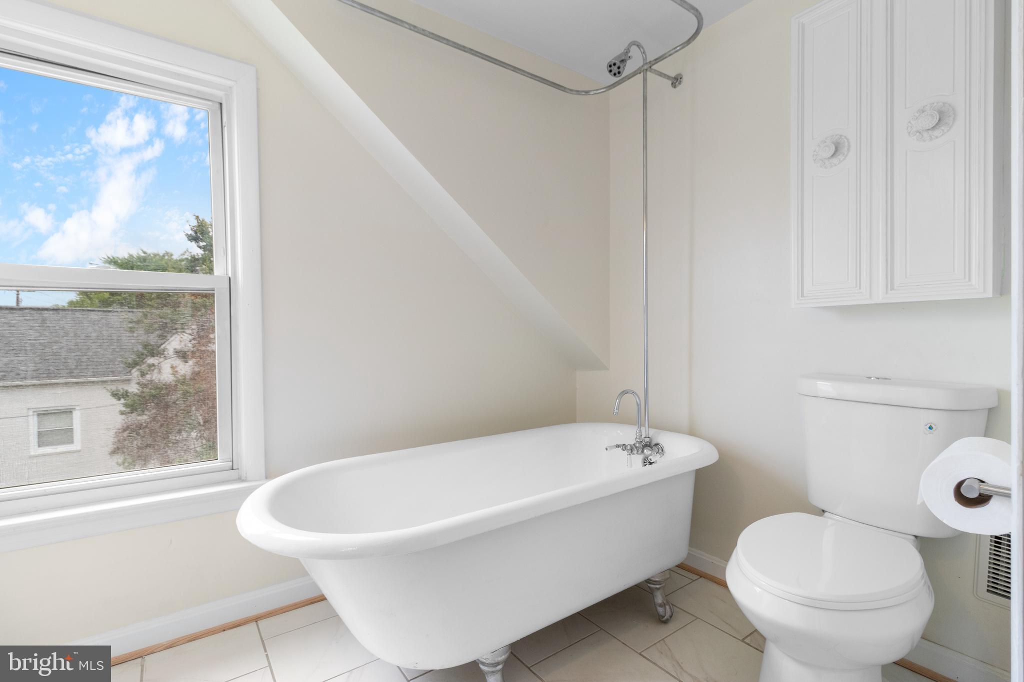 1504 Taylor Avenue, Unit A Parkville, MD 21234 - Photo 19 of 27 a white toilet sitting next to a bath tub