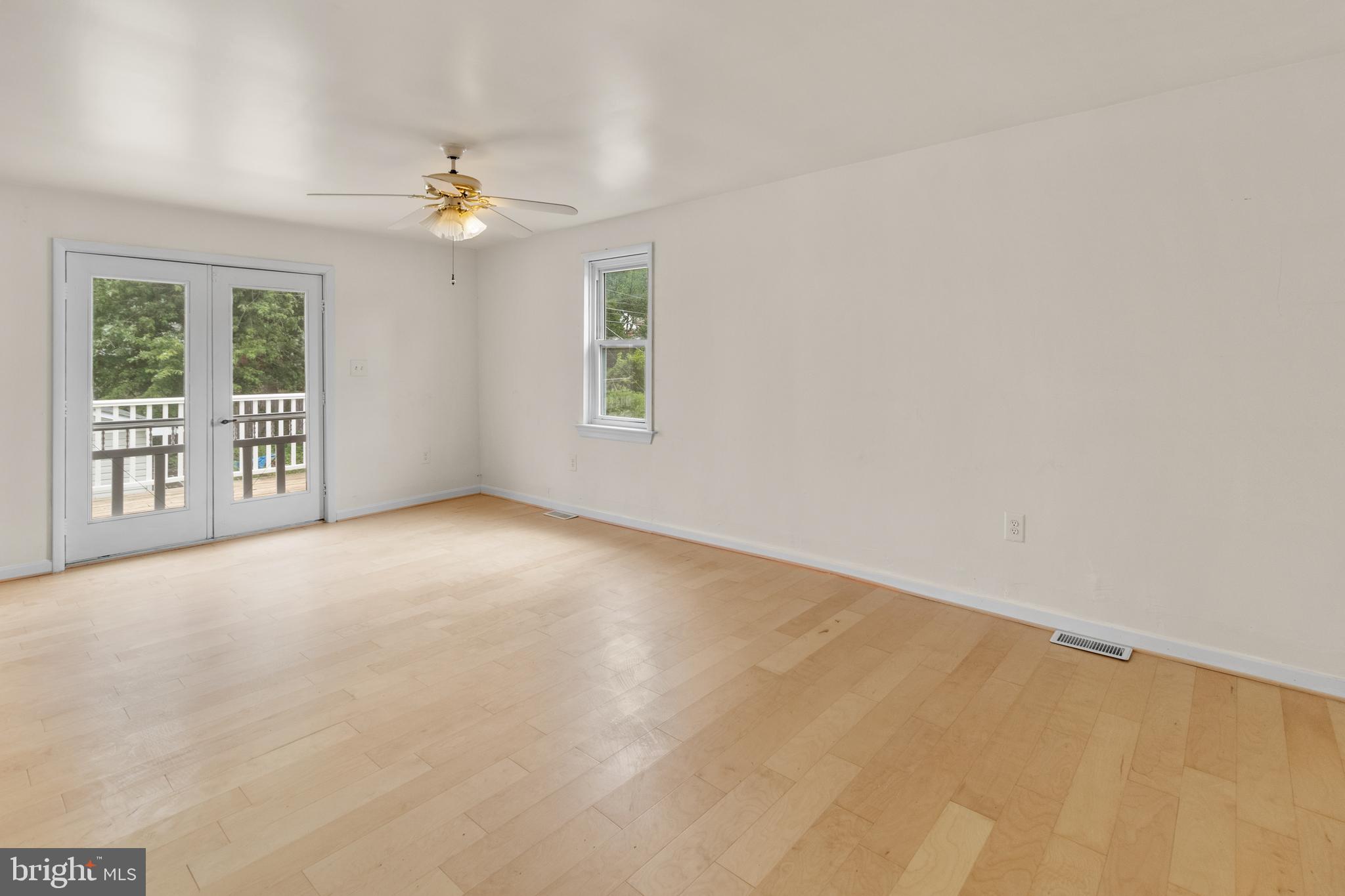 1504 Taylor Avenue, Unit A Parkville, MD 21234 - Photo 20 of 27 an empty room with windows and chandelier fan