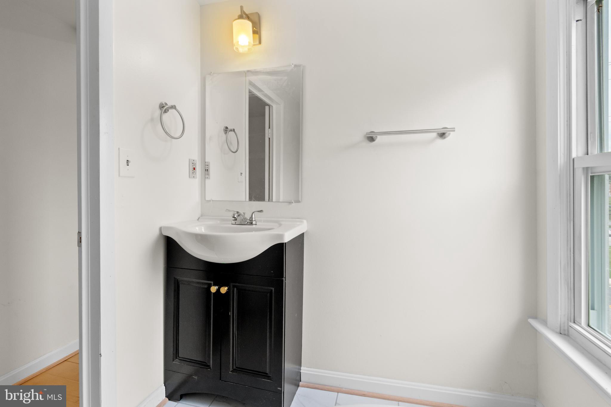 1504 Taylor Avenue, Unit A Parkville, MD 21234 - Photo 24 of 27 a bathroom with a sink and a mirror