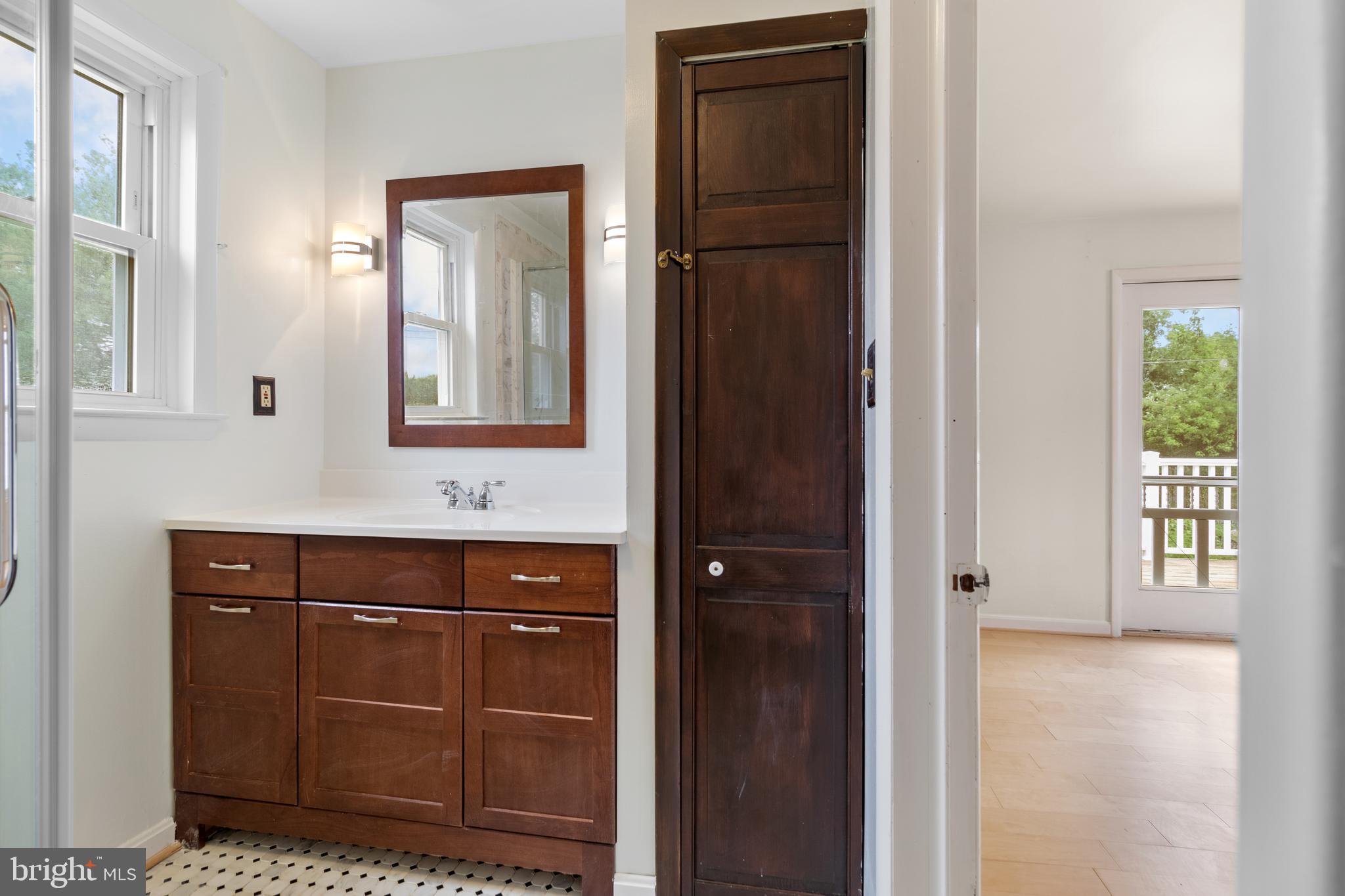 1504 Taylor Avenue, Unit A Parkville, MD 21234 - Photo 26 of 27 a bathroom with a sink a mirror and window