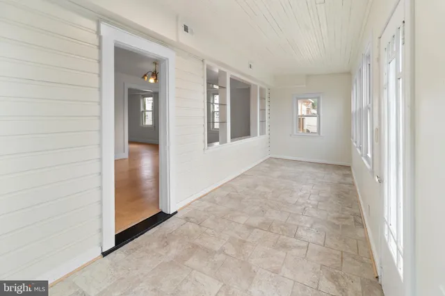 an empty room with windows and closet