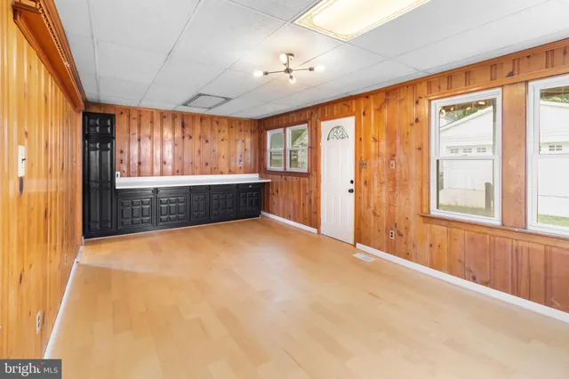 an empty room with windows and closet