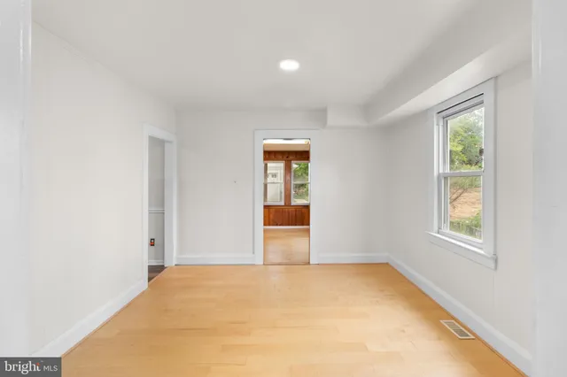 wooden floor in an empty room with a window