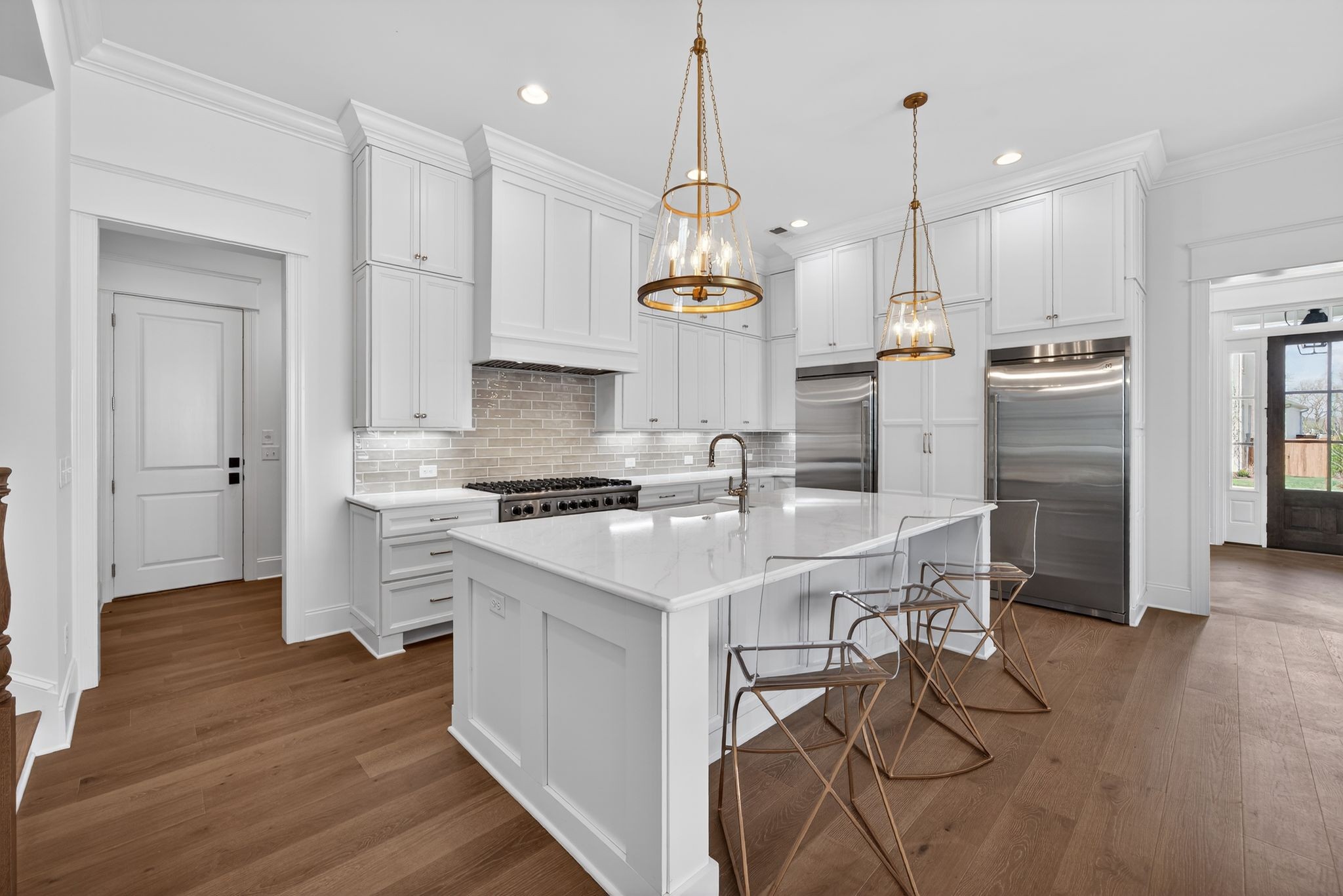 7042 Kinderhook Road Nashville, TN 37221 - Photo 17 of 87 a kitchen with stainless steel appliances kitchen island a sink a refrigerator and chairs