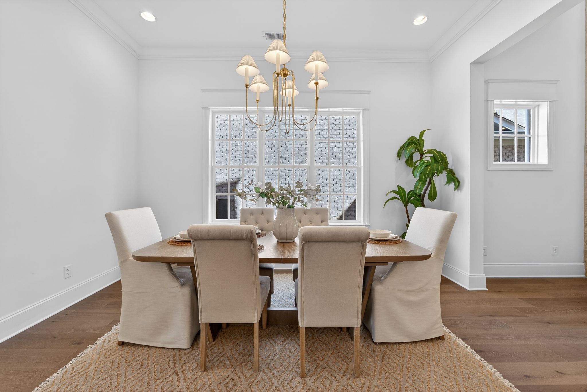 7042 Kinderhook Road Nashville, TN 37221 - Photo 20 of 87 a dining room with furniture potted plants and wooden floor
