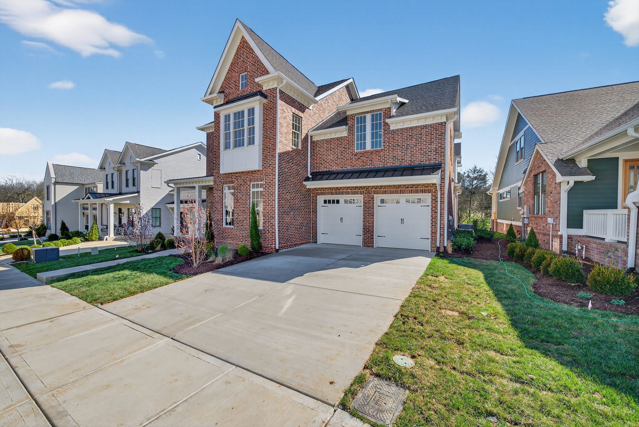 7042 Kinderhook Road Nashville, TN 37221 - Photo 3 of 87 a front view of a house with a yard and garage