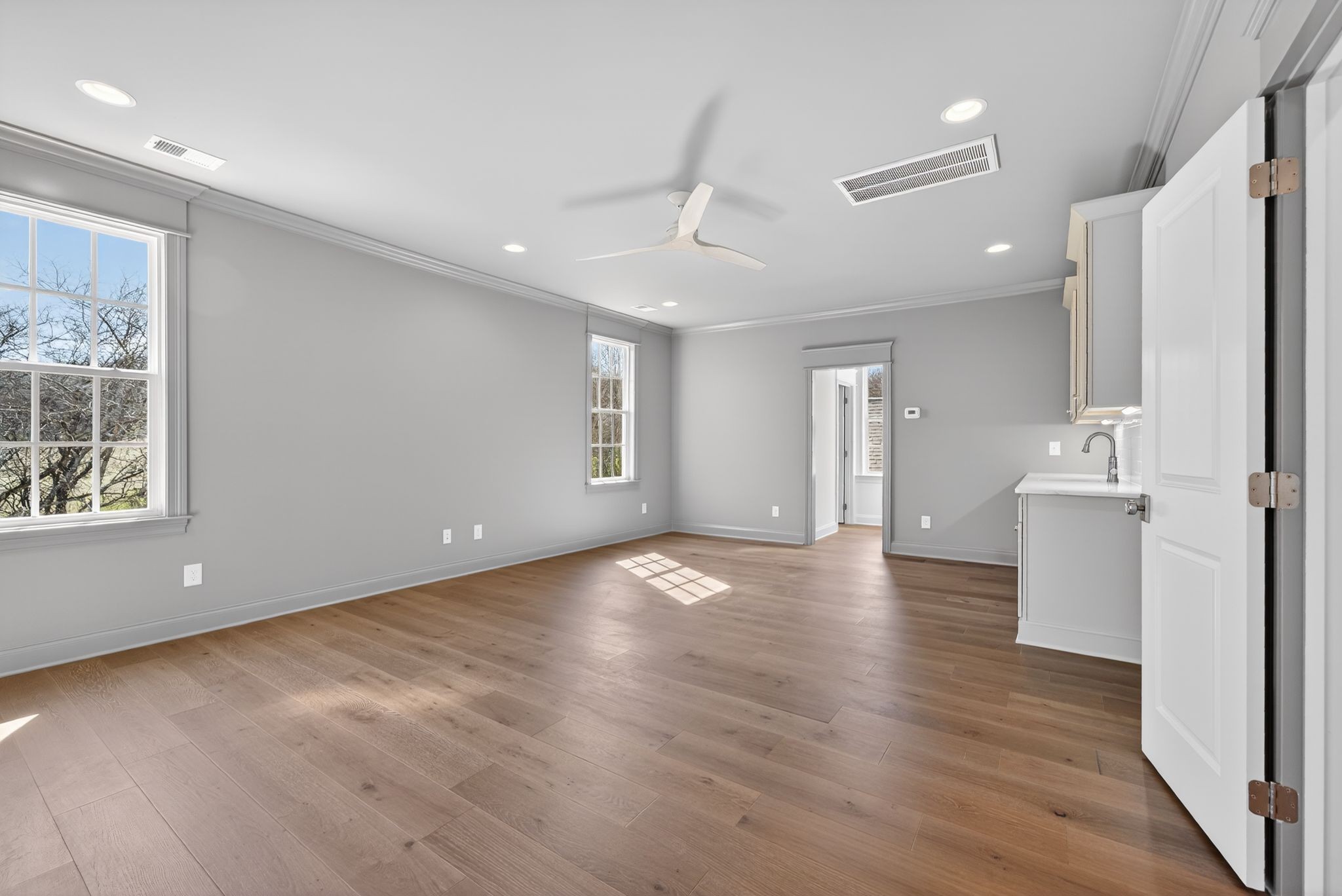 7042 Kinderhook Road Nashville, TN 37221 - Photo 73 of 87 a view of an empty room with wooden floor and a kitchen