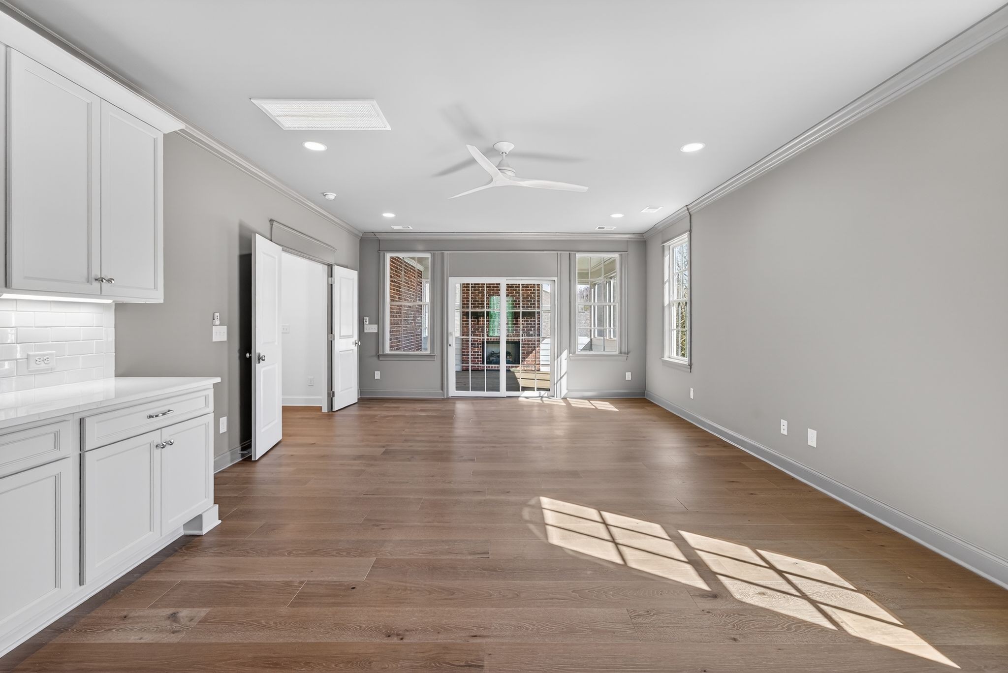 7042 Kinderhook Road Nashville, TN 37221 - Photo 76 of 87 a view of an empty room with a window and wooden floor