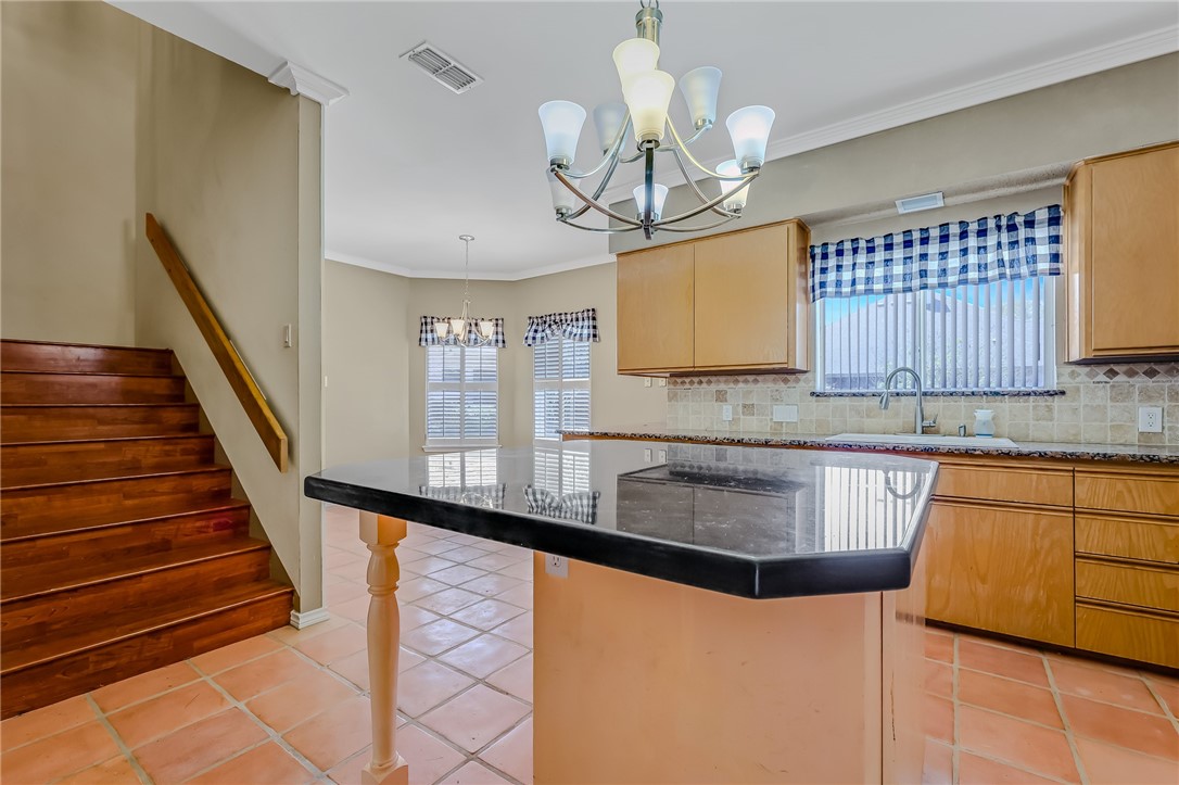 5917 Harvest Hill Road Corpus Christi, TX 78414 - Photo 20 of 40 a kitchen with stainless steel appliances granite countertop wooden cabinets a stove a sink and dishwasher