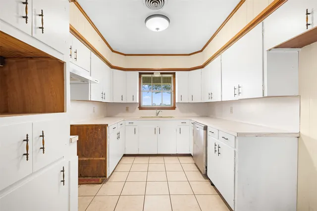 a kitchen with granite countertop white cabinets and white appliances