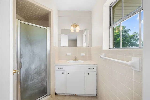a view of a room with a window and a ceiling fan