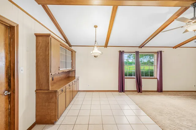 a view of hallway with a ceiling fan