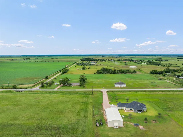 a view of a garden with a building in the background