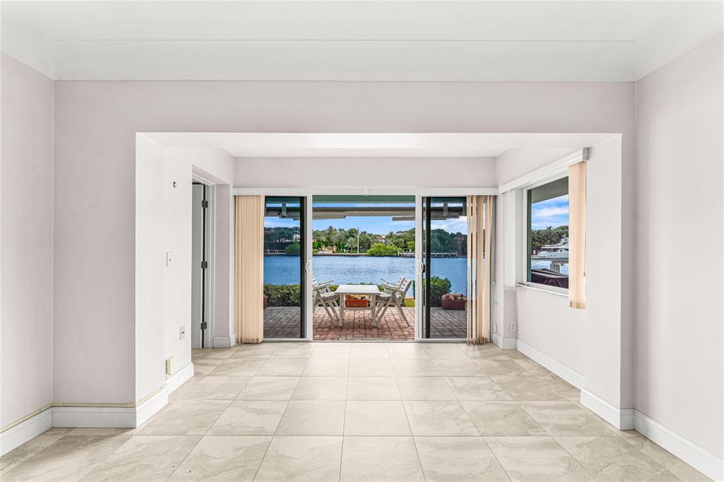 2758 Northeast 30th Avenue, Unit 1A Lighthouse Point, FL 33064 - Photo 31 of 48 a view of a hallway with an outdoor space