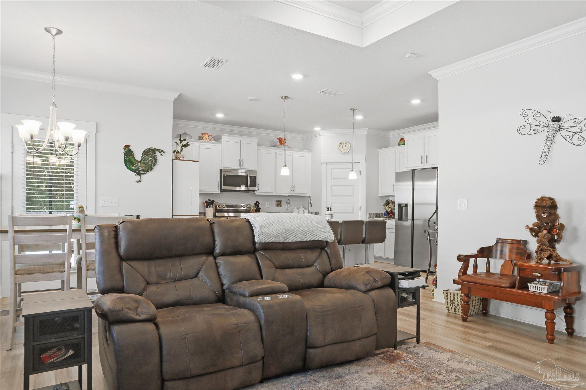 1932 Appleton Drive Cantonment, FL 32533 - Photo 14 of 57 a living room with furniture kitchen view and a chandelier