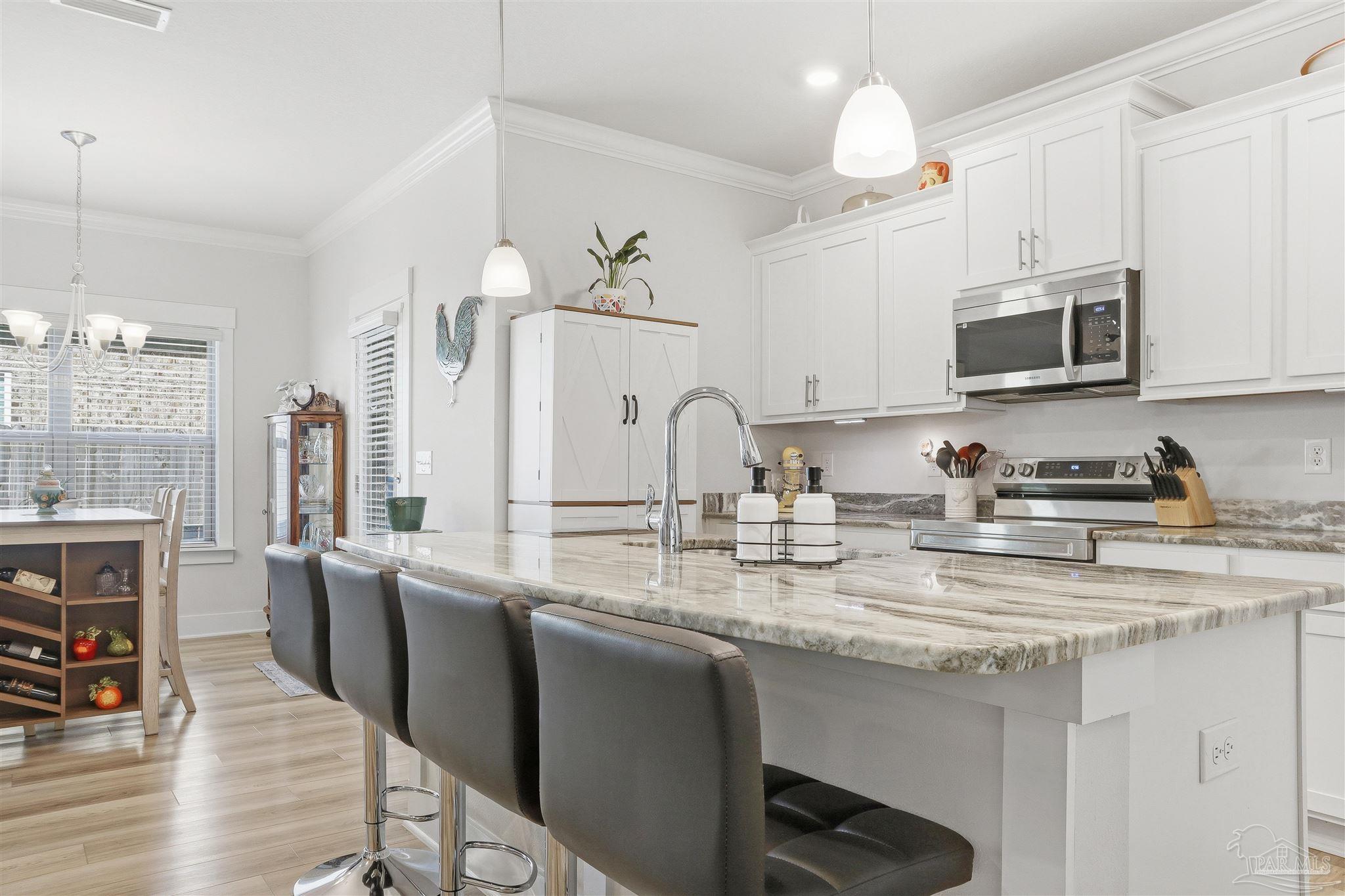 1932 Appleton Drive Cantonment, FL 32533 - Photo 16 of 57 a kitchen with stainless steel appliances granite countertop a sink dishwasher a microwave oven a stove with island and cabinets