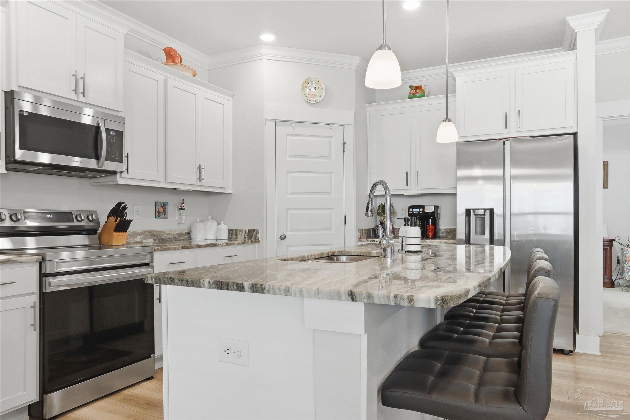 1932 Appleton Drive Cantonment, FL 32533 - Photo 19 of 57 a kitchen with stainless steel appliances granite countertop a sink a stove and cabinets
