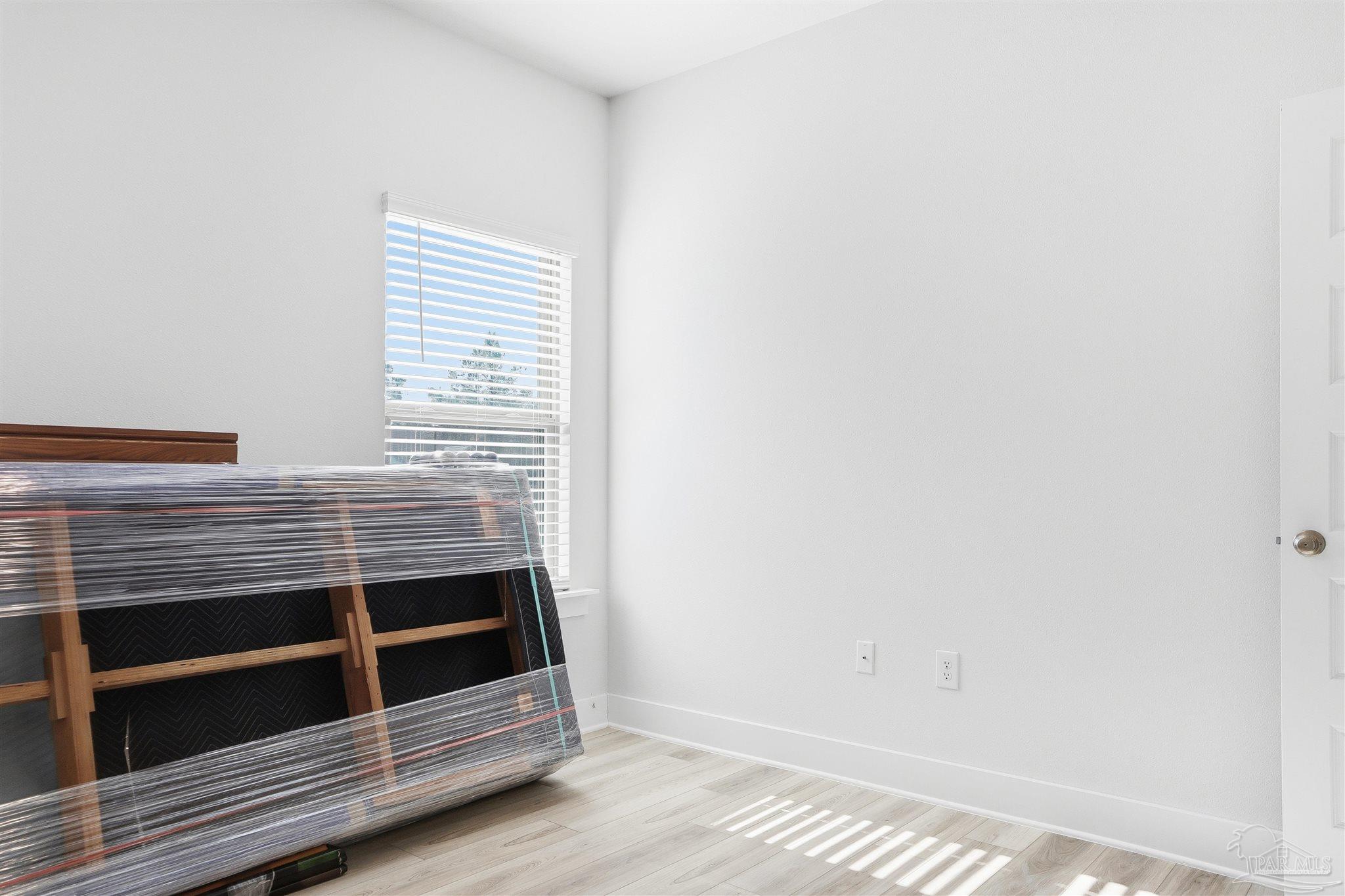 1932 Appleton Drive Cantonment, FL 32533 - Photo 23 of 57 a view of an empty room with wooden floor and a window