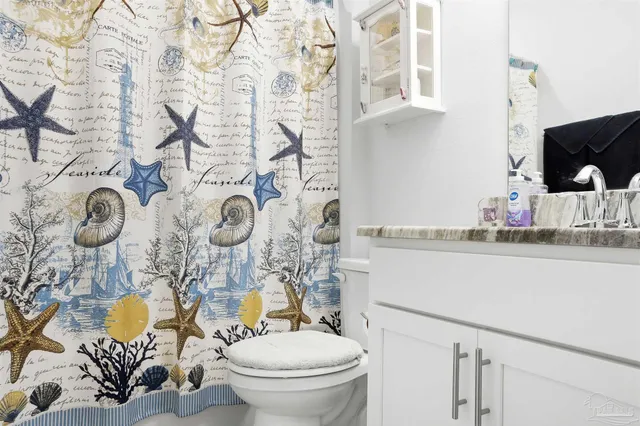 a bedroom with a bed and a dresser with mirror