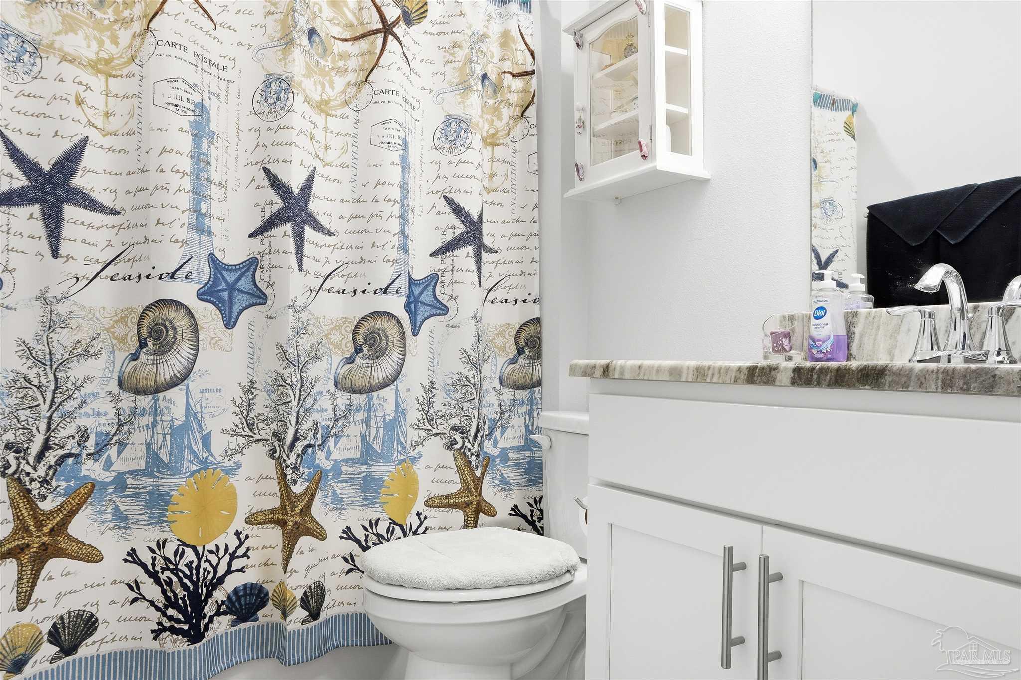 1932 Appleton Drive Cantonment, FL 32533 - Photo 26 of 57 a bathroom with a toilet sink and mirror