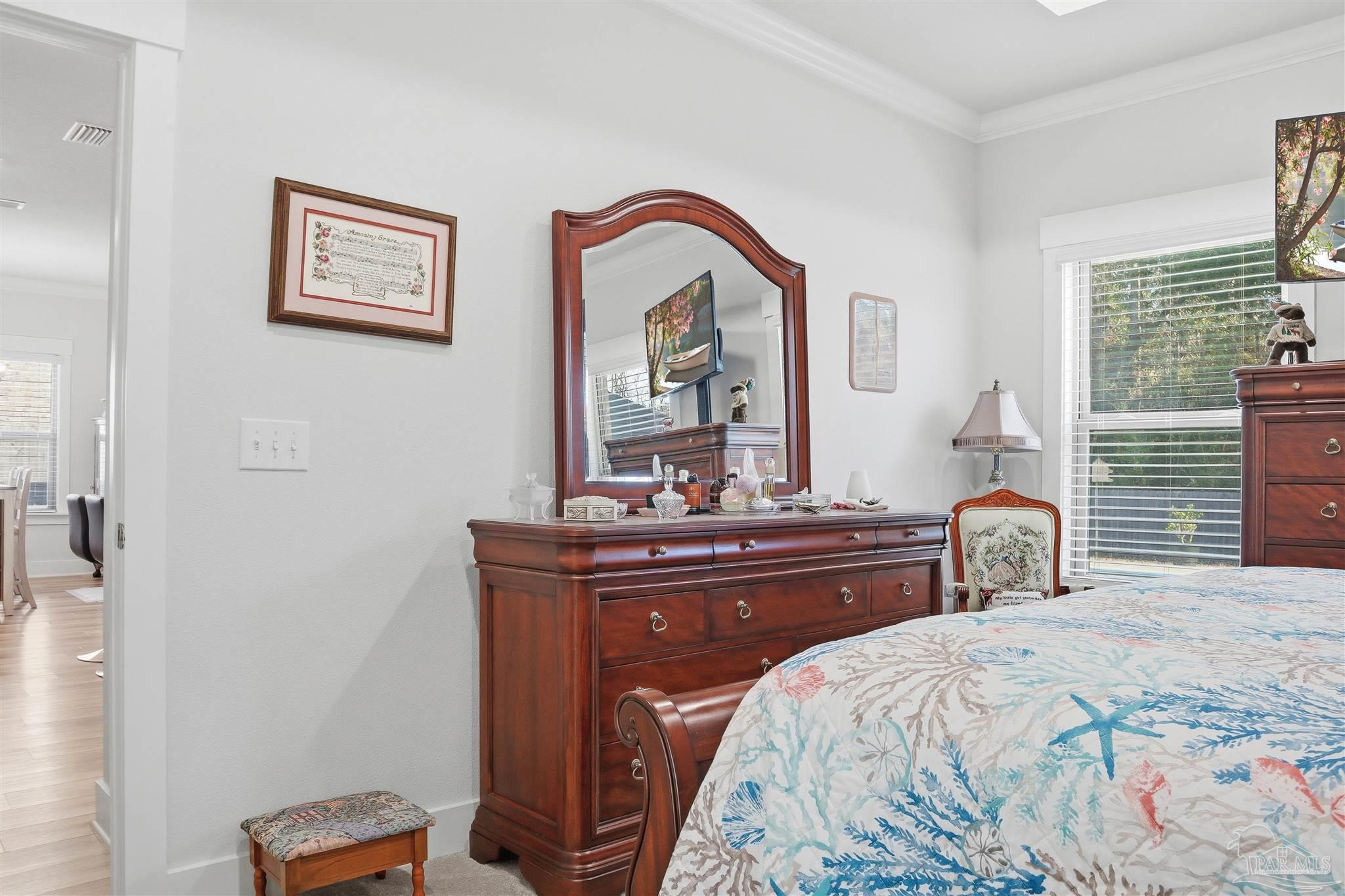 1932 Appleton Drive Cantonment, FL 32533 - Photo 29 of 57 a bedroom with a bed and a dresser with mirror