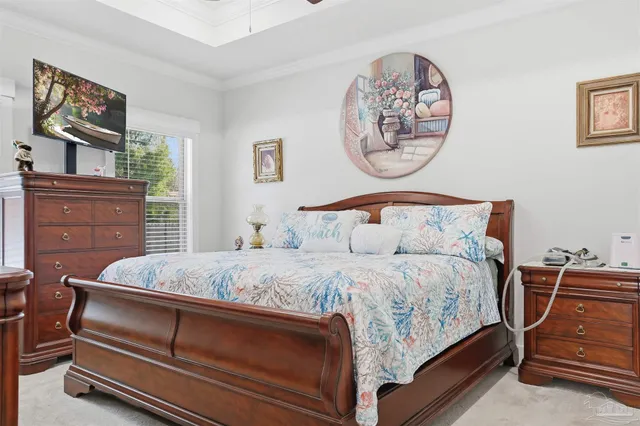 a bedroom with a bed and a dresser in it