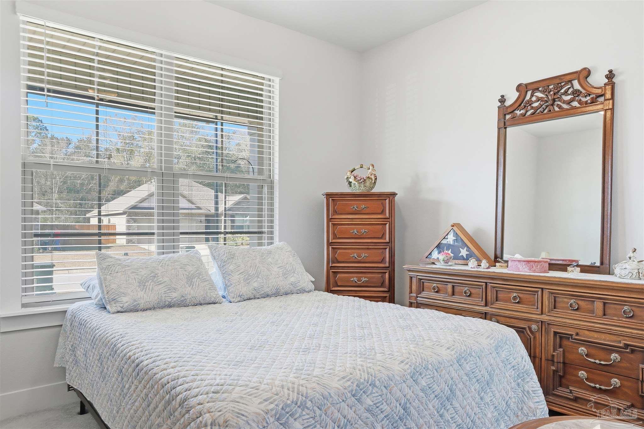 1932 Appleton Drive Cantonment, FL 32533 - Photo 31 of 57 a bedroom with a bed and a large window