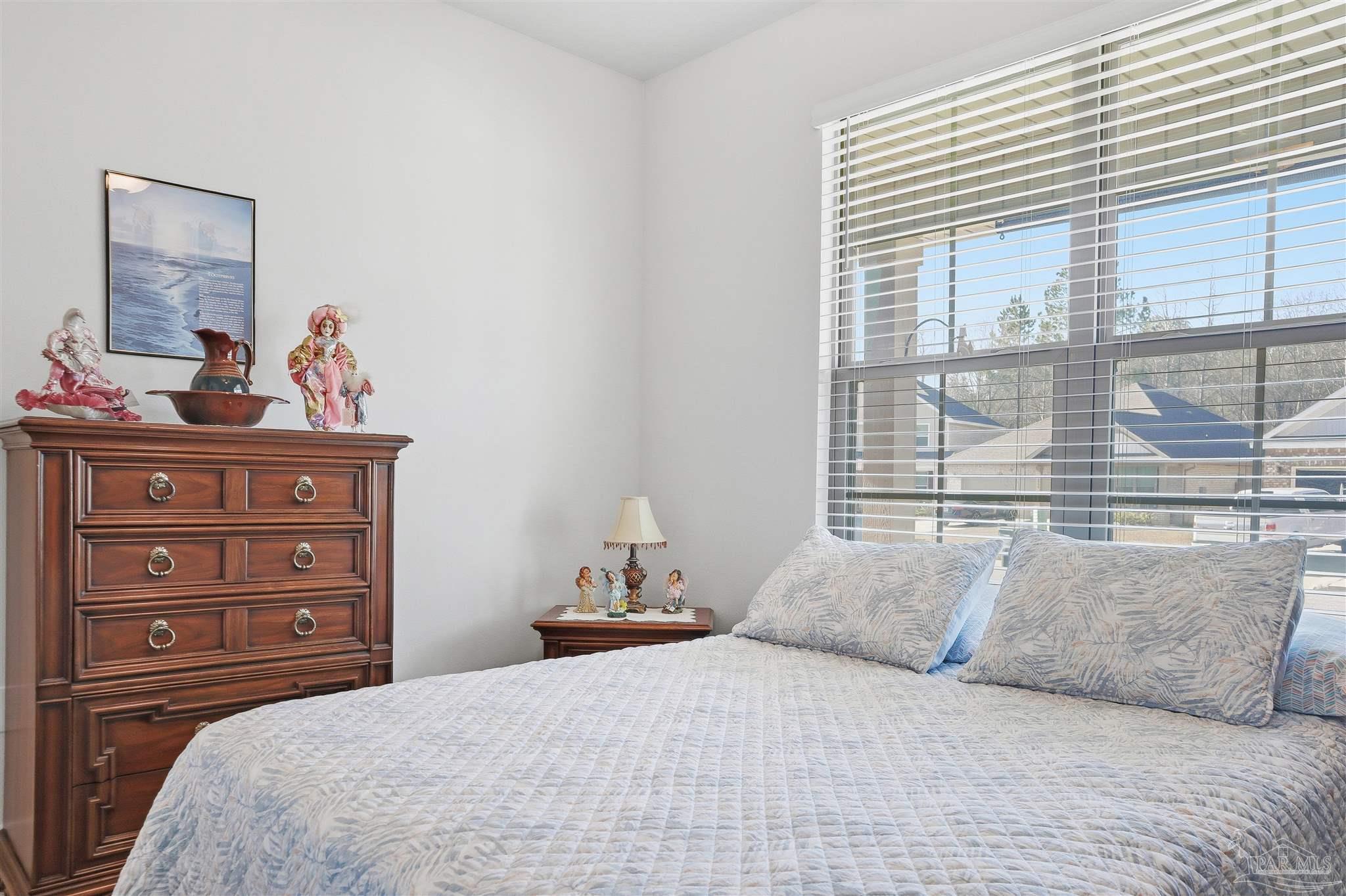 1932 Appleton Drive Cantonment, FL 32533 - Photo 32 of 57 a bedroom with a bed and a large window