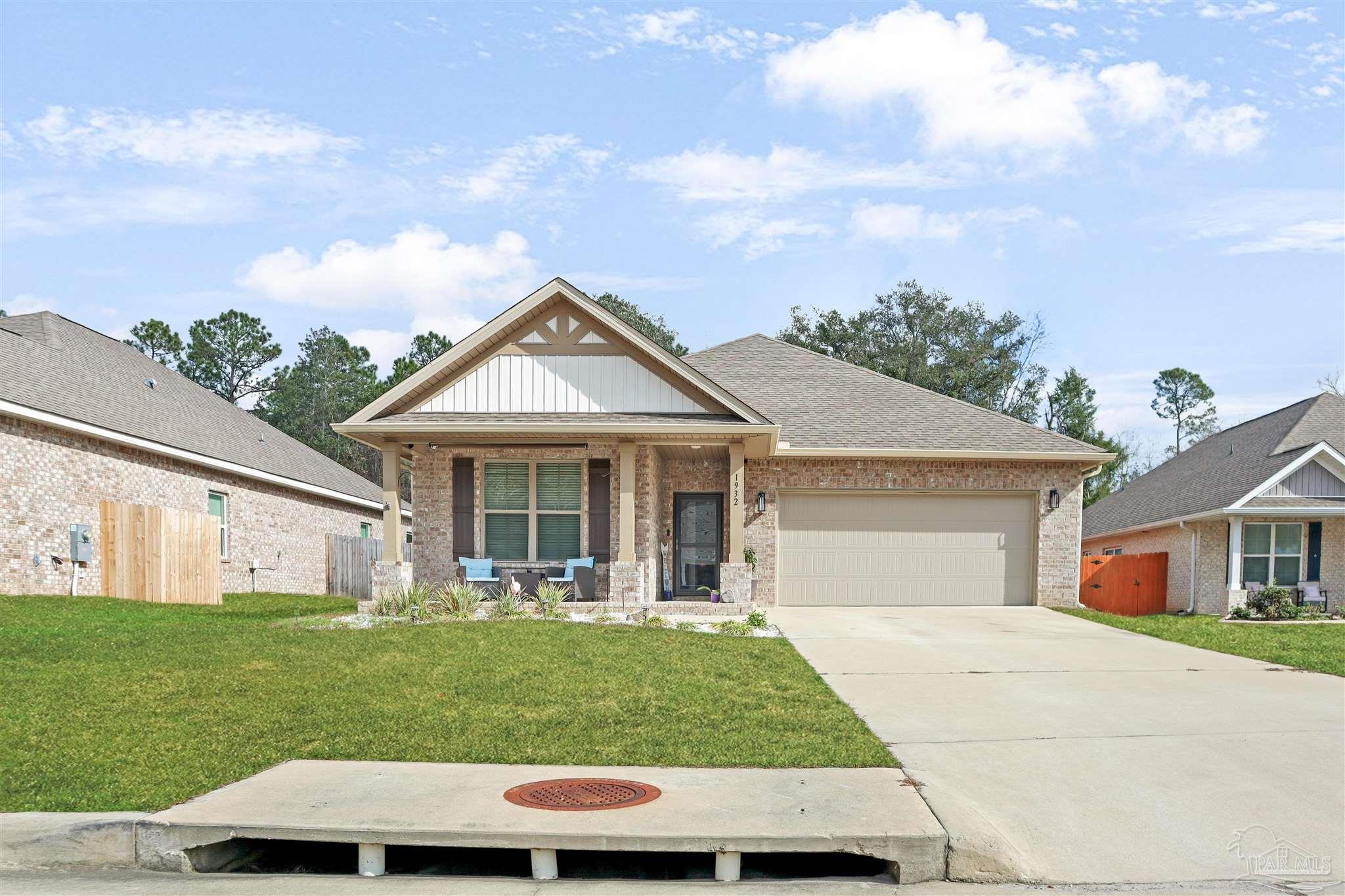 1932 Appleton Drive Cantonment, FL 32533 - Photo 4 of 57 a view of a white house in front of a yard with potted plants