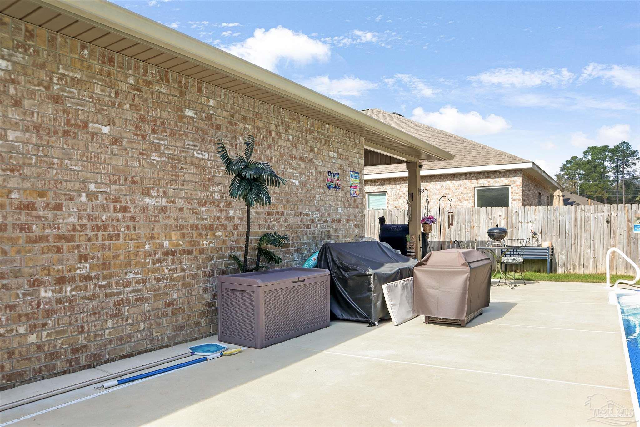 1932 Appleton Drive Cantonment, FL 32533 - Photo 50 of 57 a view of a patio with couches chairs and potted plants