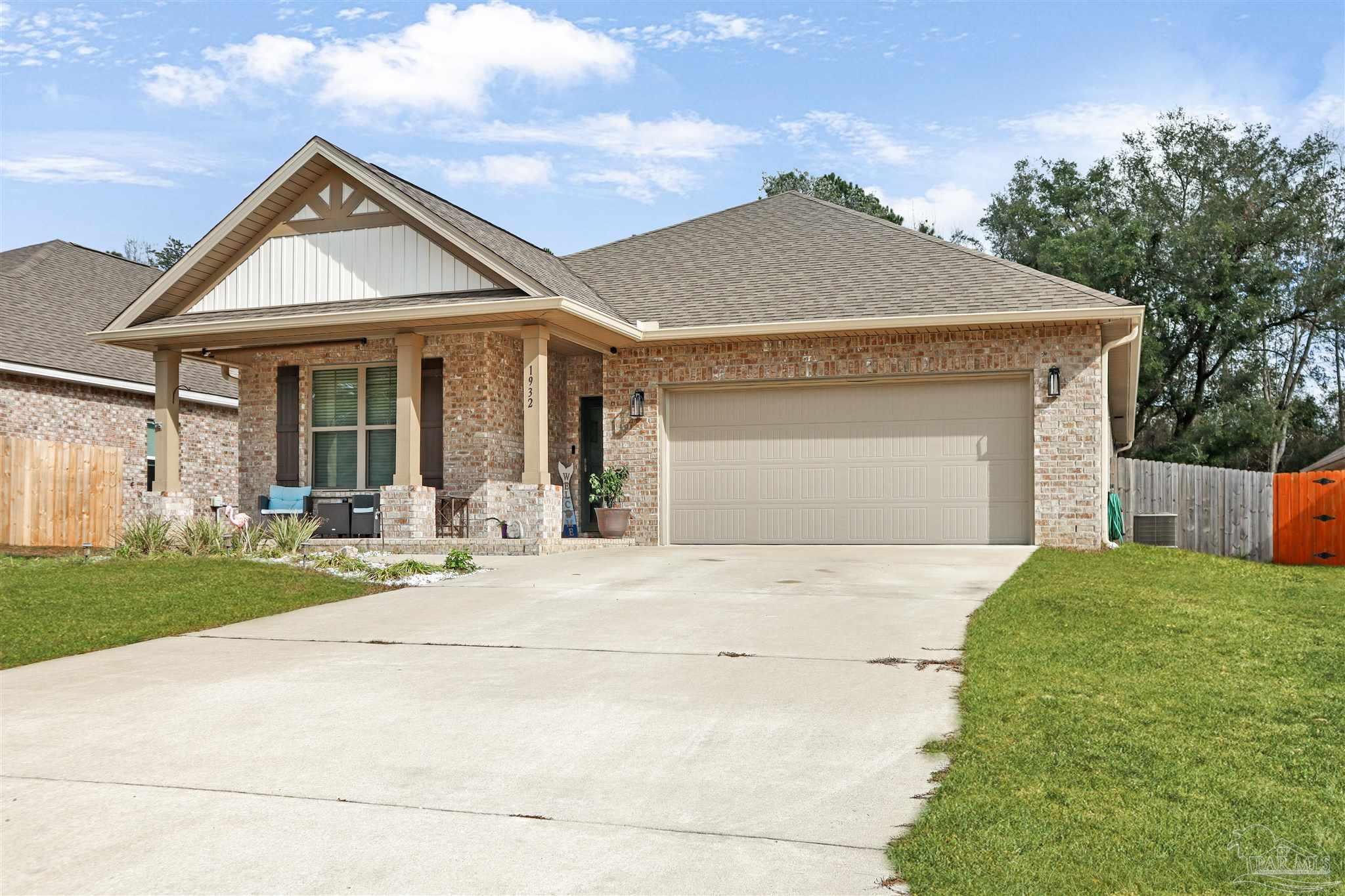 1932 Appleton Drive Cantonment, FL 32533 - Photo 5 of 57 a front view of a house with a yard and garage