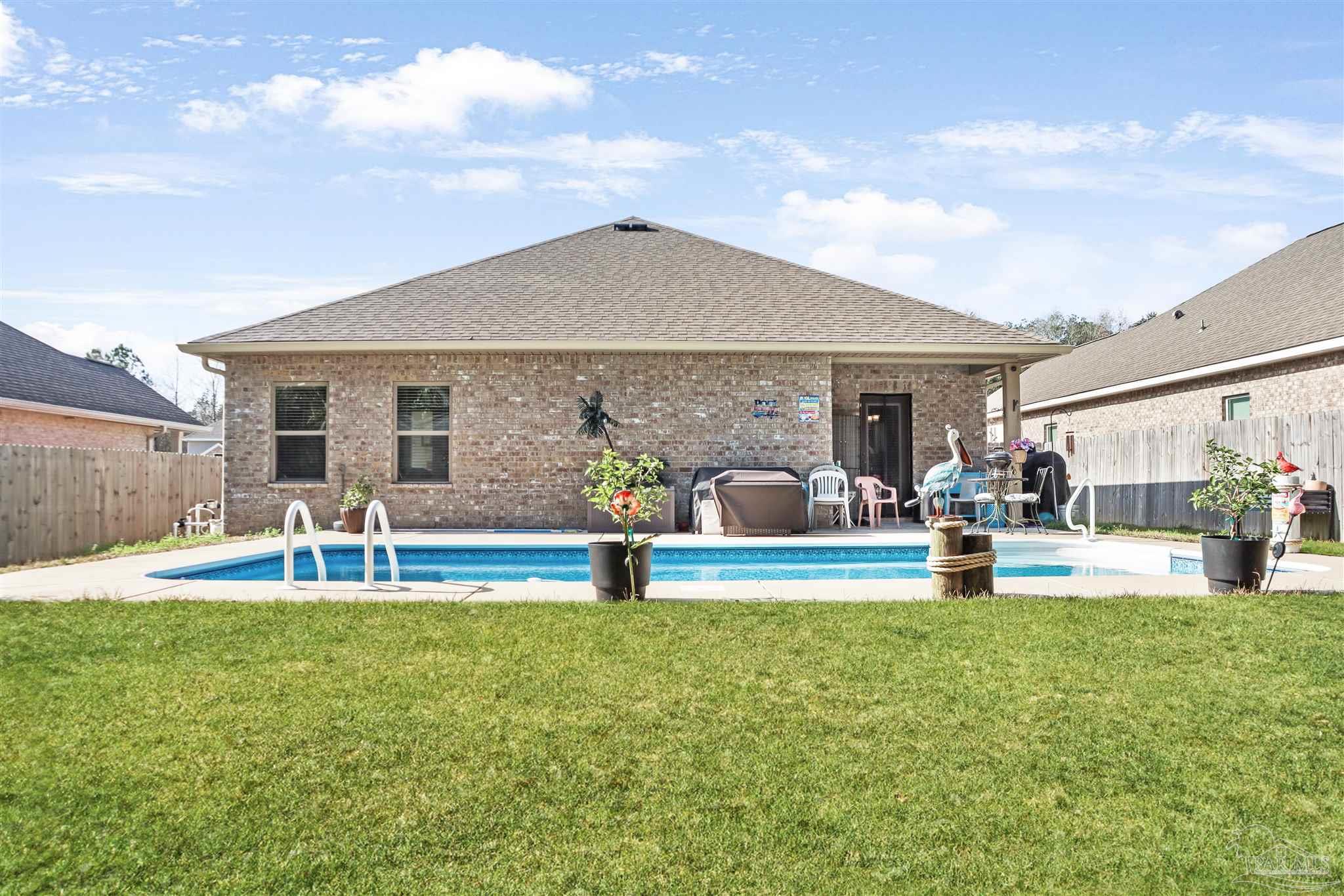 1932 Appleton Drive Cantonment, FL 32533 - Photo 53 of 57 a front view of house with yard and seating area