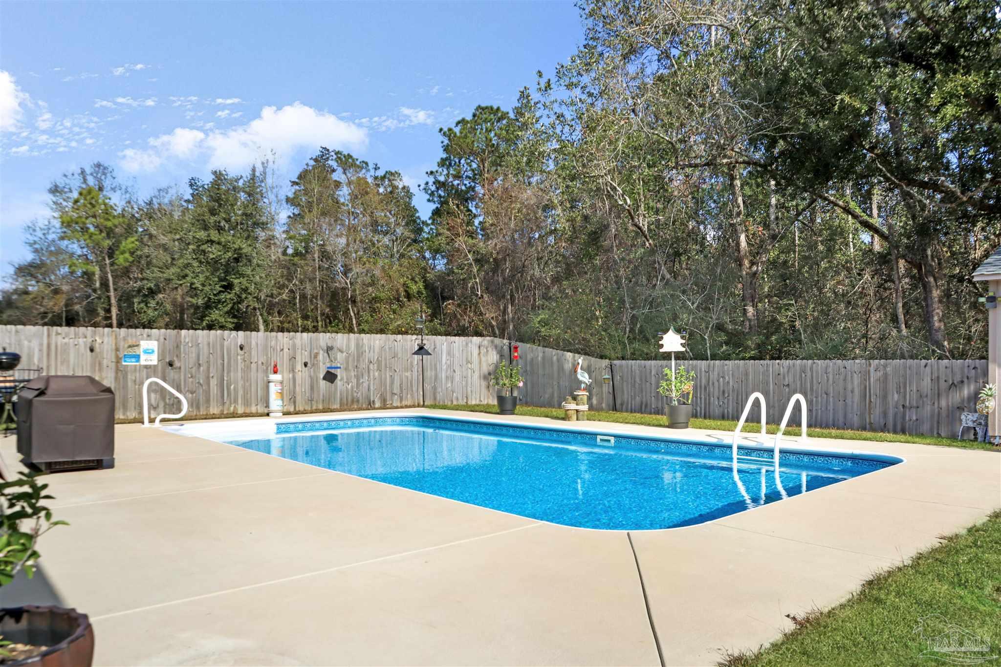 1932 Appleton Drive Cantonment, FL 32533 - Photo 55 of 57 a view of a swimming pool with a patio and a yard