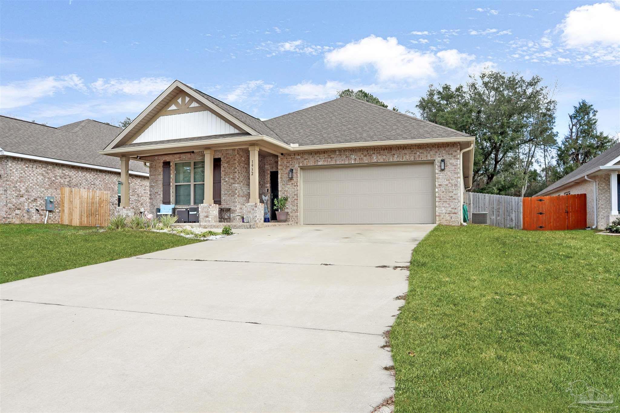 1932 Appleton Drive Cantonment, FL 32533 - Photo 6 of 57 a front view of house with yard and trees in the background