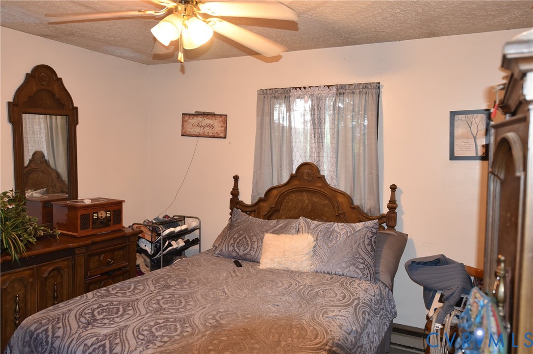 642 Star Street Pounding Mill, VA 24637 - Photo 12 of 20 Room featuring light-colored walls, a ceiling fan