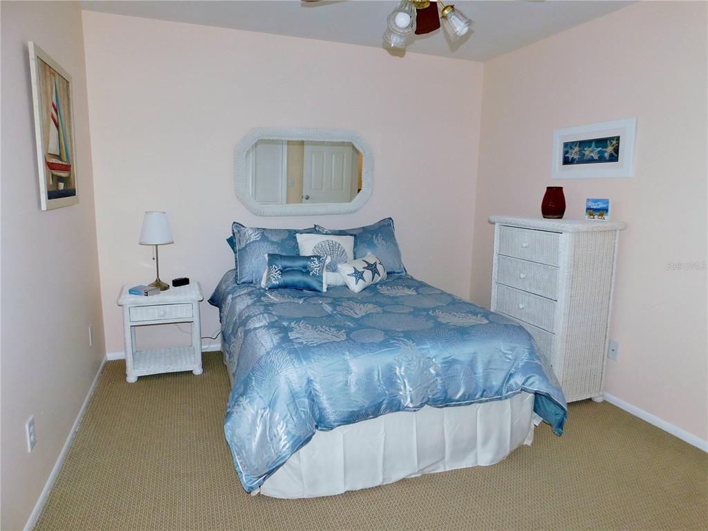 40 Dale Place Oldsmar, FL 34677 - Photo 16 of 32 a bedroom with a bed and a chandelier
