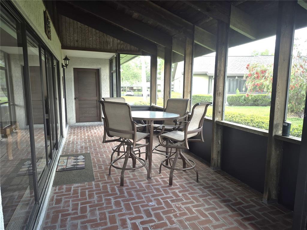 40 Dale Place Oldsmar, FL 34677 - Photo 24 of 32 a view of a dining room with furniture and a floor to ceiling window