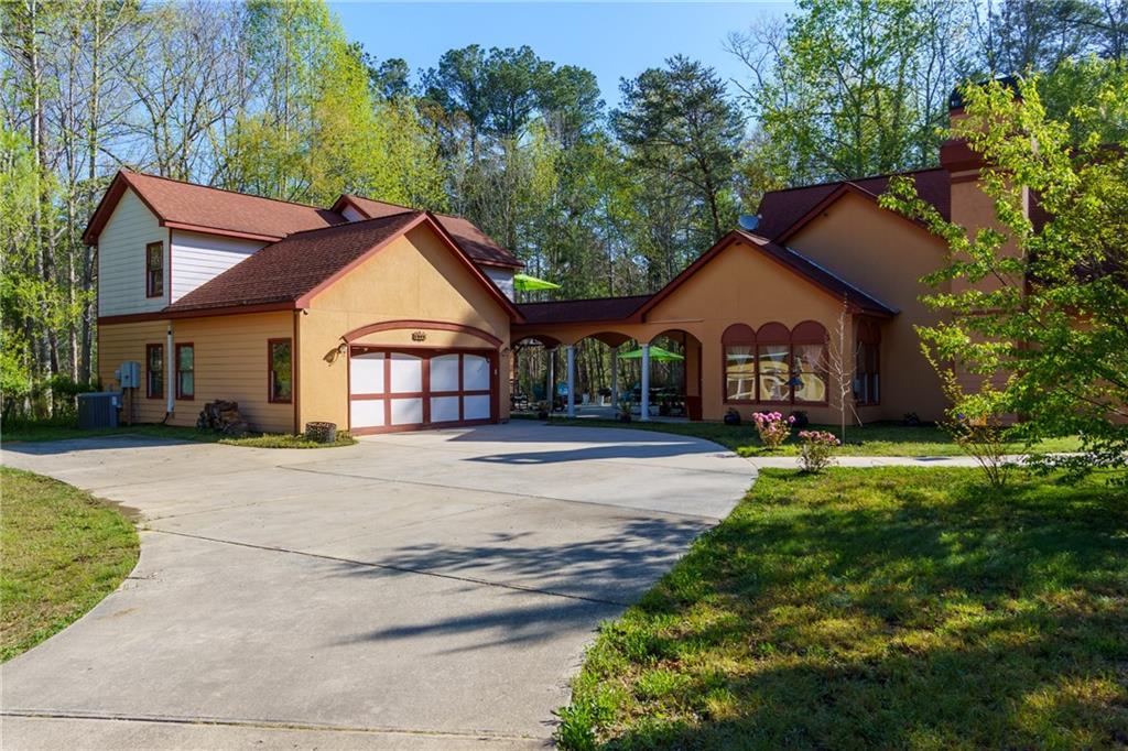 1045 Fincher Road Canton, GA 30114 - Photo 2 of 49 a front view of a house with a garden and pathway