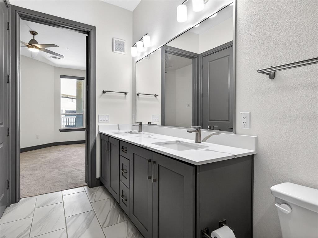 2700 Old Denton Road, Unit 3370 Carrollton, TX 75007 - Photo 20 of 35 a bathroom with a granite countertop sink and a mirror