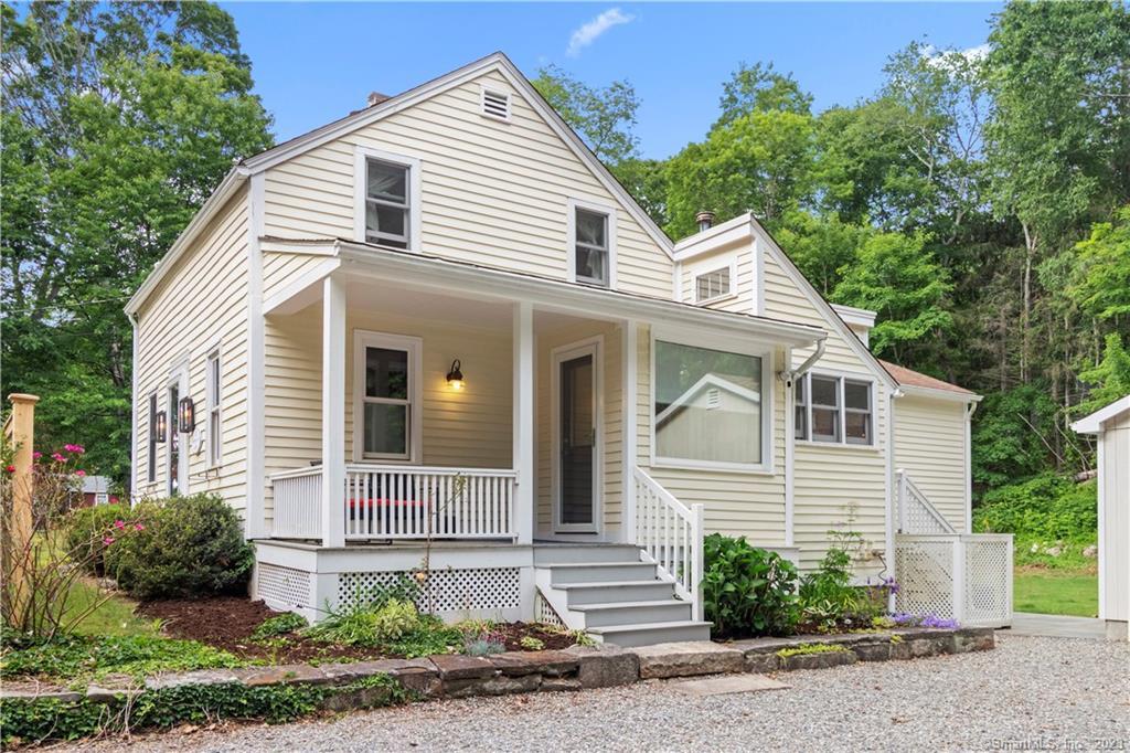 99 Book Hill Road Essex, CT 06426 - Photo 1 of 1 a view of a white house next to a yard and large tree