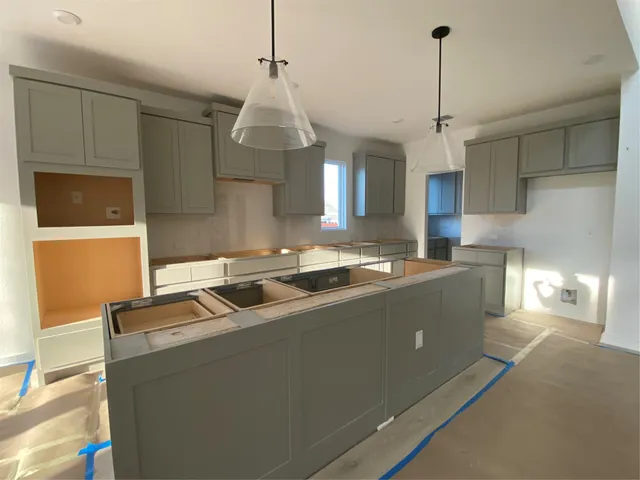 a kitchen with stainless steel appliances granite countertop a sink a counter space and cabinets