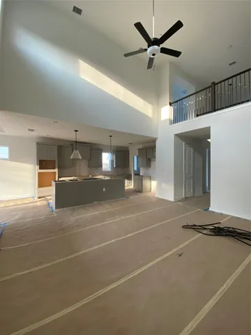 a room with gym equipment and a ceiling fan
