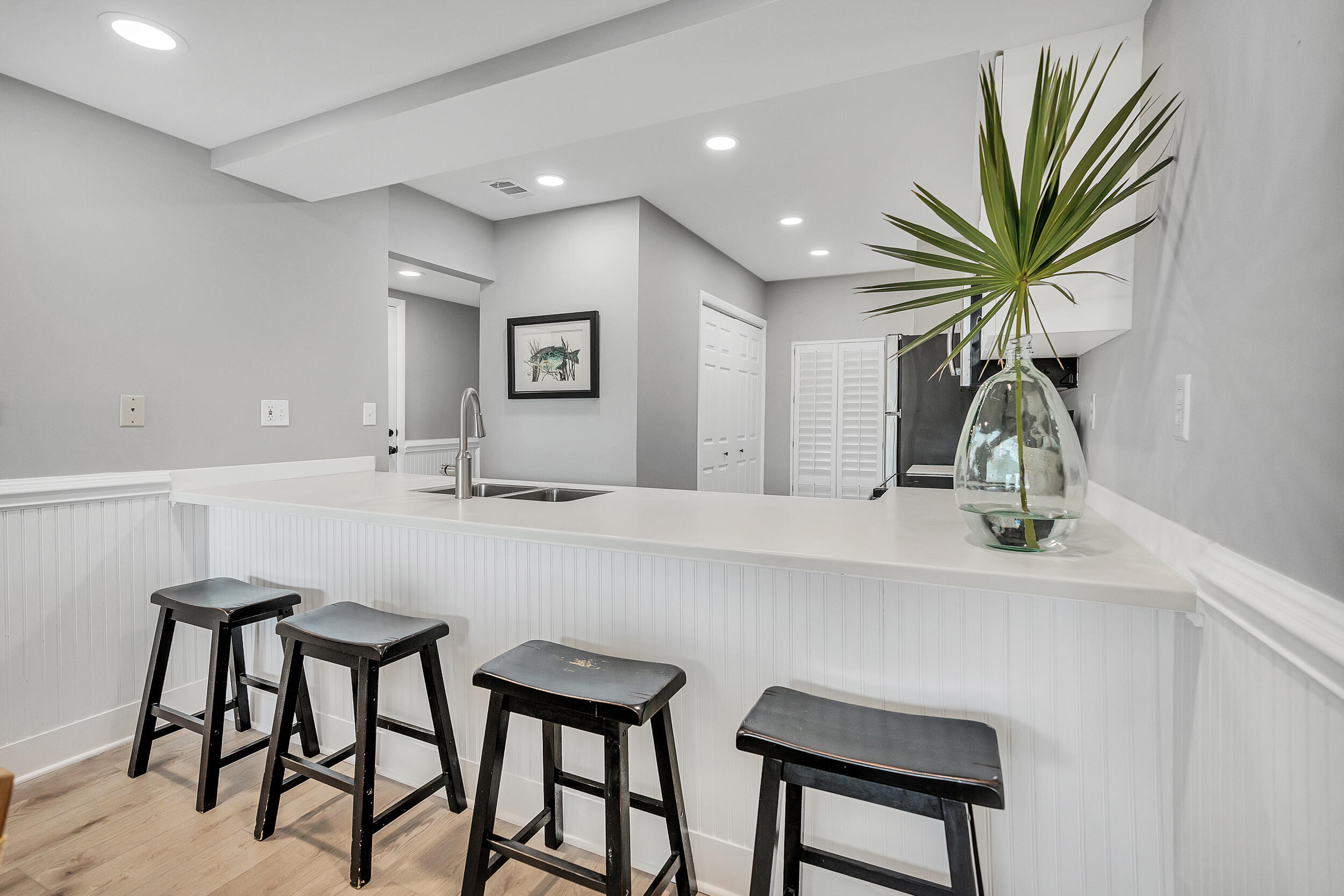 10254 East Co Highway, Unit 233 Inlet Beach, FL 32461 - Photo 11 of 46 a kitchen with stainless steel appliances a table and chairs