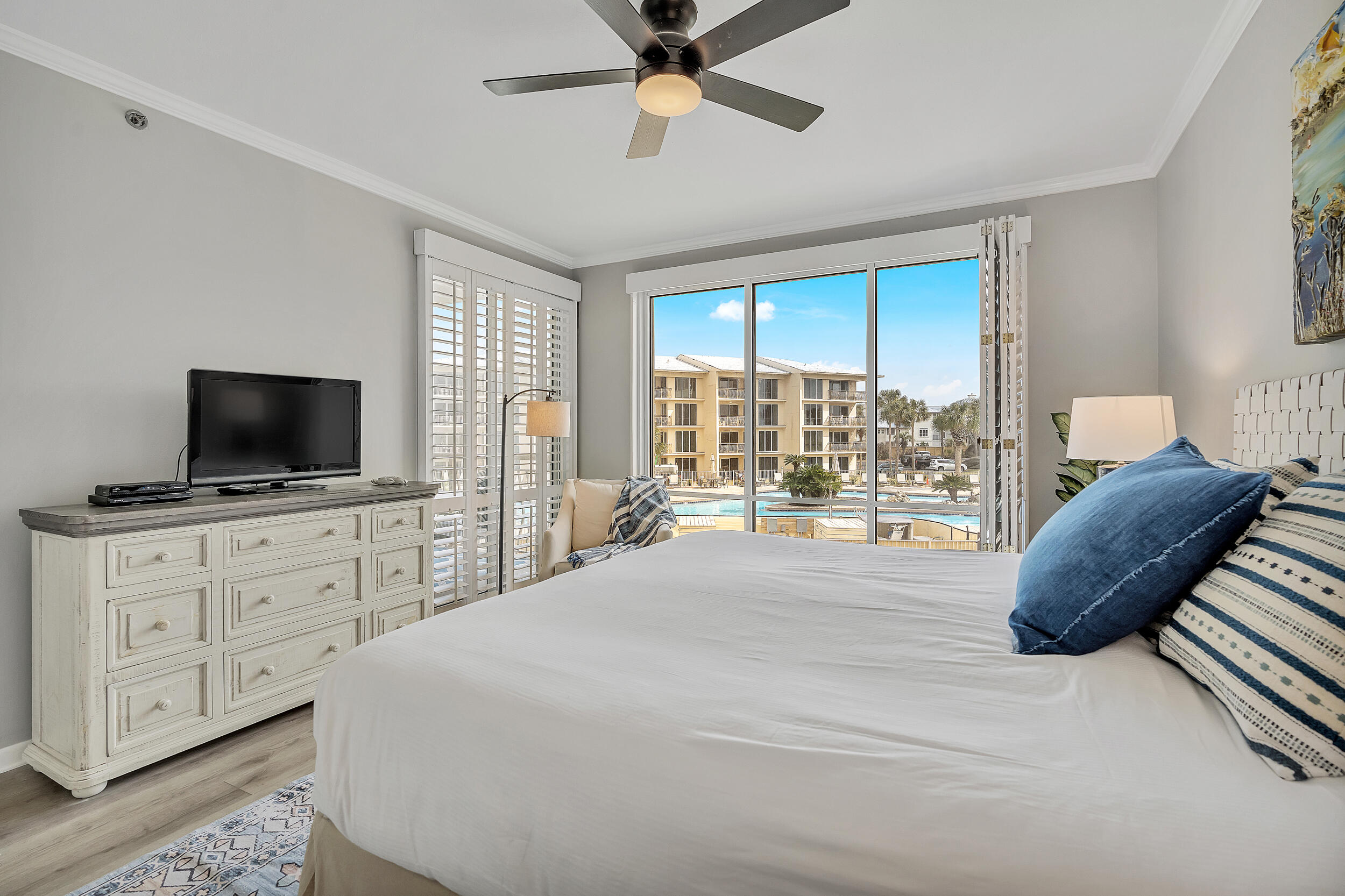 10254 East Co Highway, Unit 233 Inlet Beach, FL 32461 - Photo 21 of 46 a bedroom with a large bed and a flat tv screen on dresser