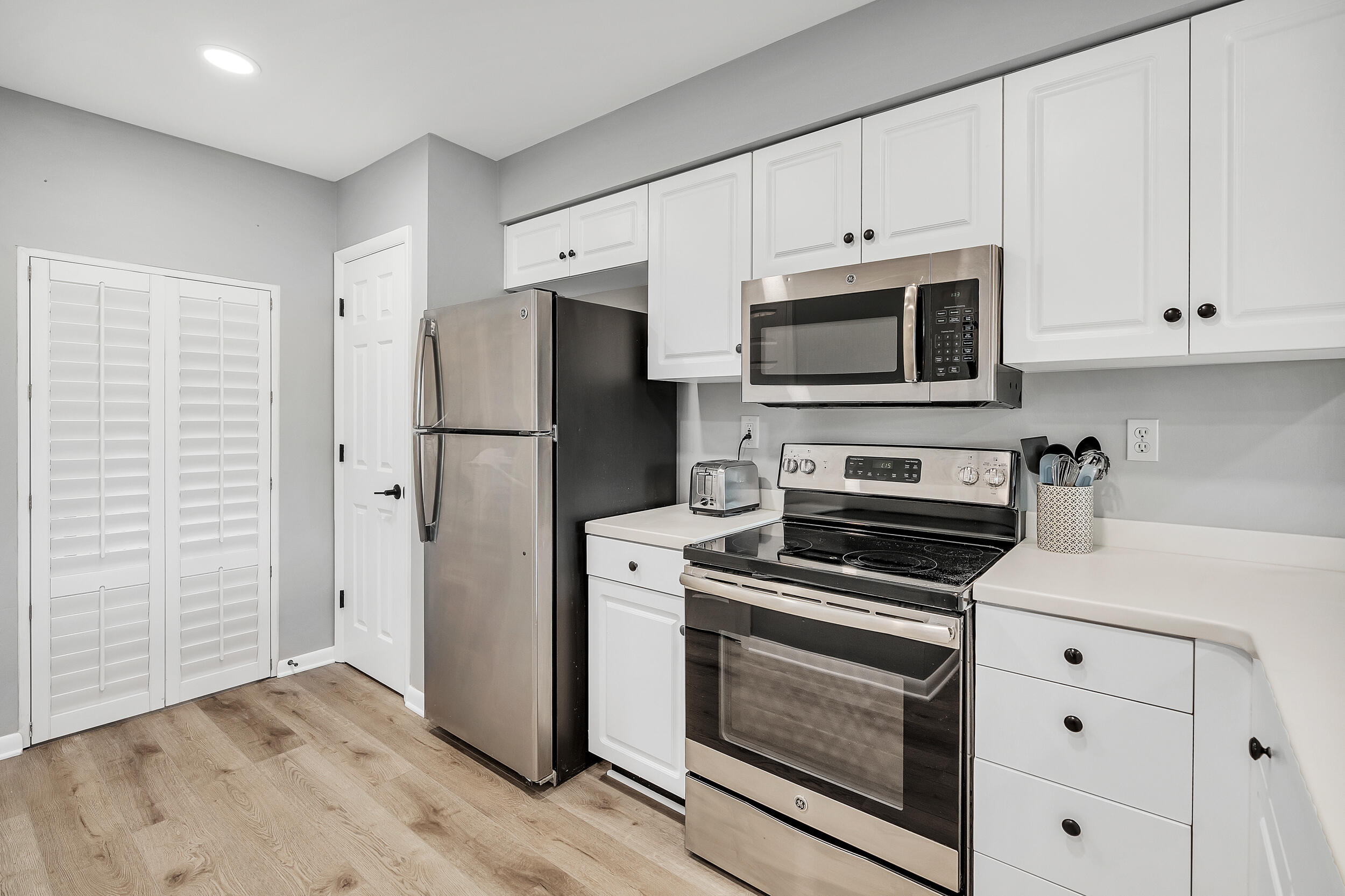 10254 East Co Highway, Unit 233 Inlet Beach, FL 32461 - Photo 4 of 46 a kitchen with cabinets stainless steel appliances and wooden floor