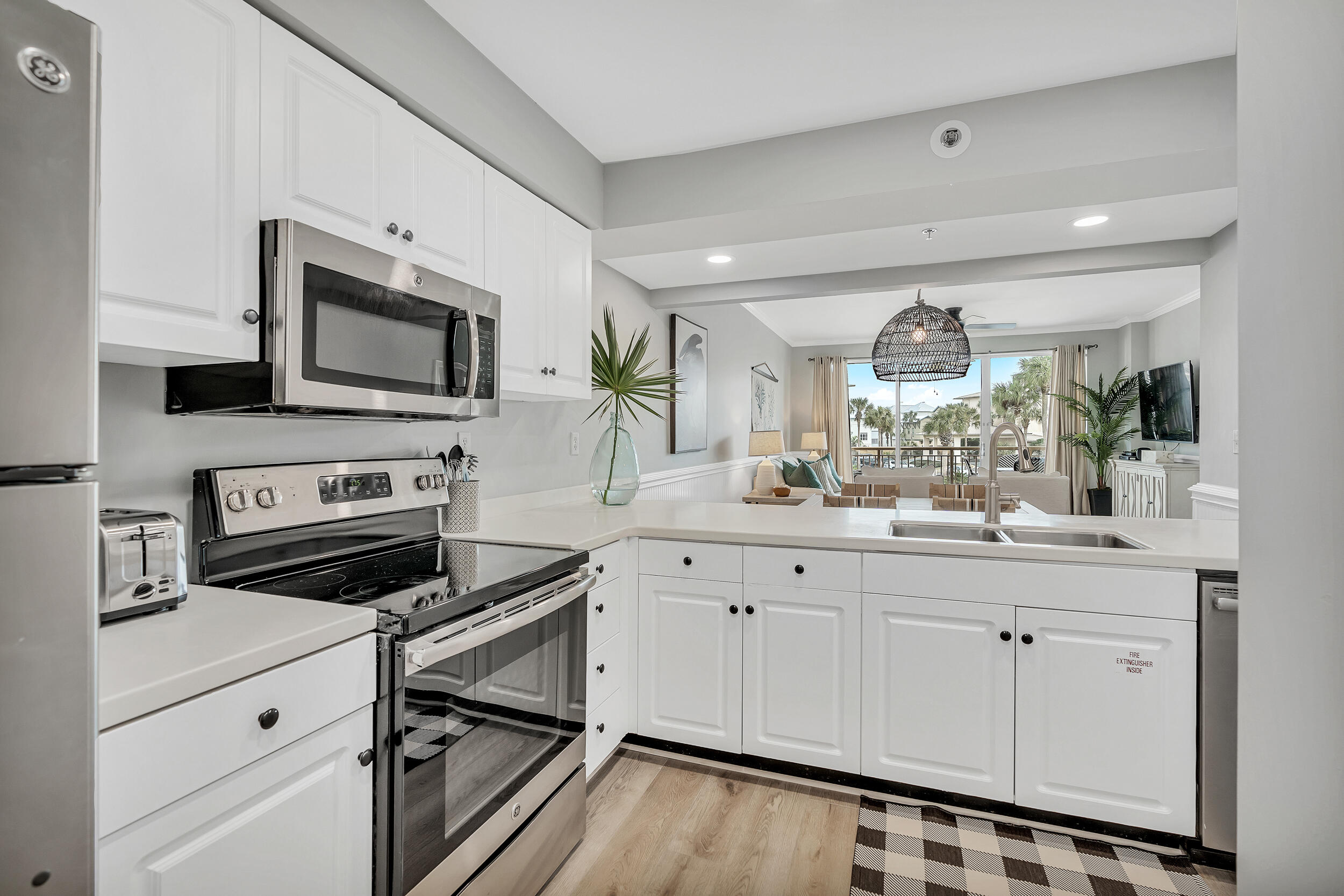 10254 East Co Highway, Unit 233 Inlet Beach, FL 32461 - Photo 5 of 46 a kitchen with granite countertop a stove a sink and a microwave