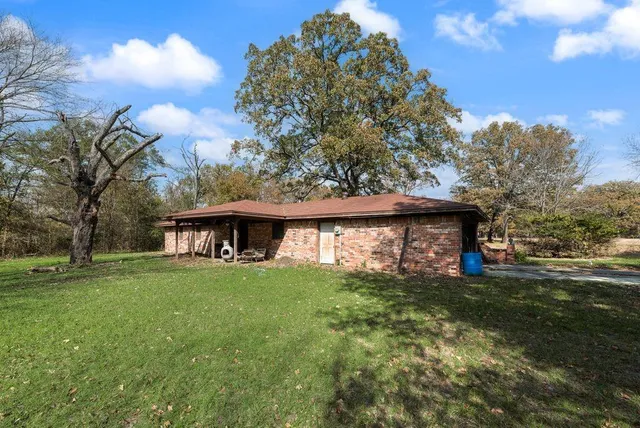 a bedroom with furniture and a large window